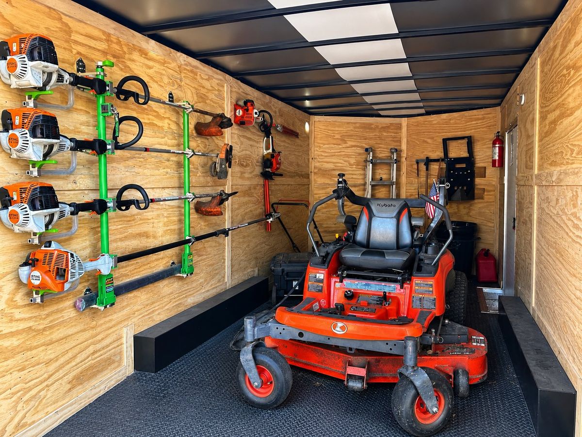 Enclosed trailer stocked with commercial mower and trimmers